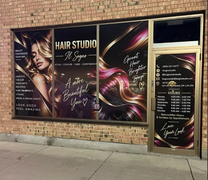 Il Sogno hair studio storefront with black, pink and gold window graphics and matching door signage.